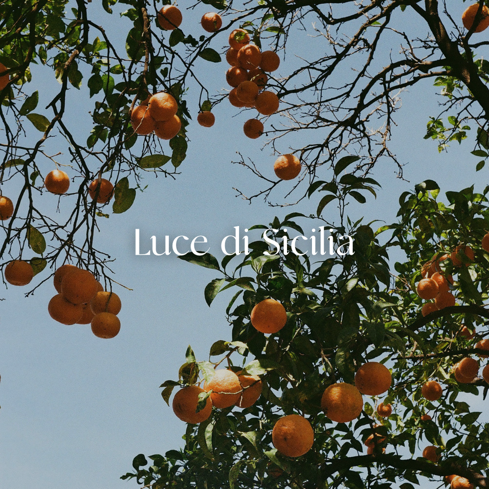 Luxury Italian-inspired candle with gilded mandarin, infused with citrine, sunstone, and orange calcite. Luce di Sicilia evokes golden Sicilian orange groves, warm sandalwood, and romantic citrus fragrance.